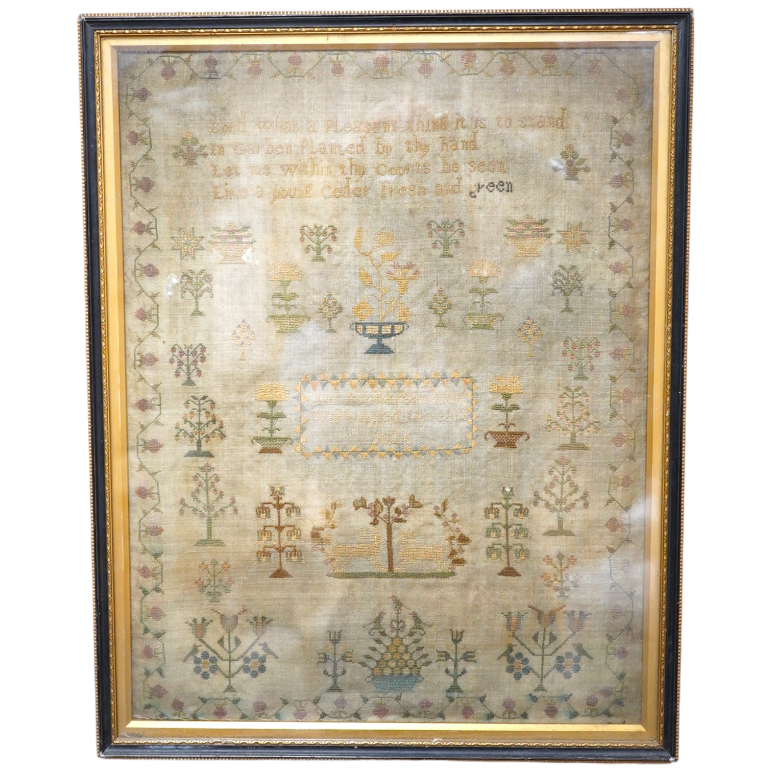 A sampler with spot motifs and central cartouche, embroidered with Ann Richardson, her work aged 14 years 1824. A very finely embroidered large spot sampler worked with motifs of stags, trees, planters of flowers with in